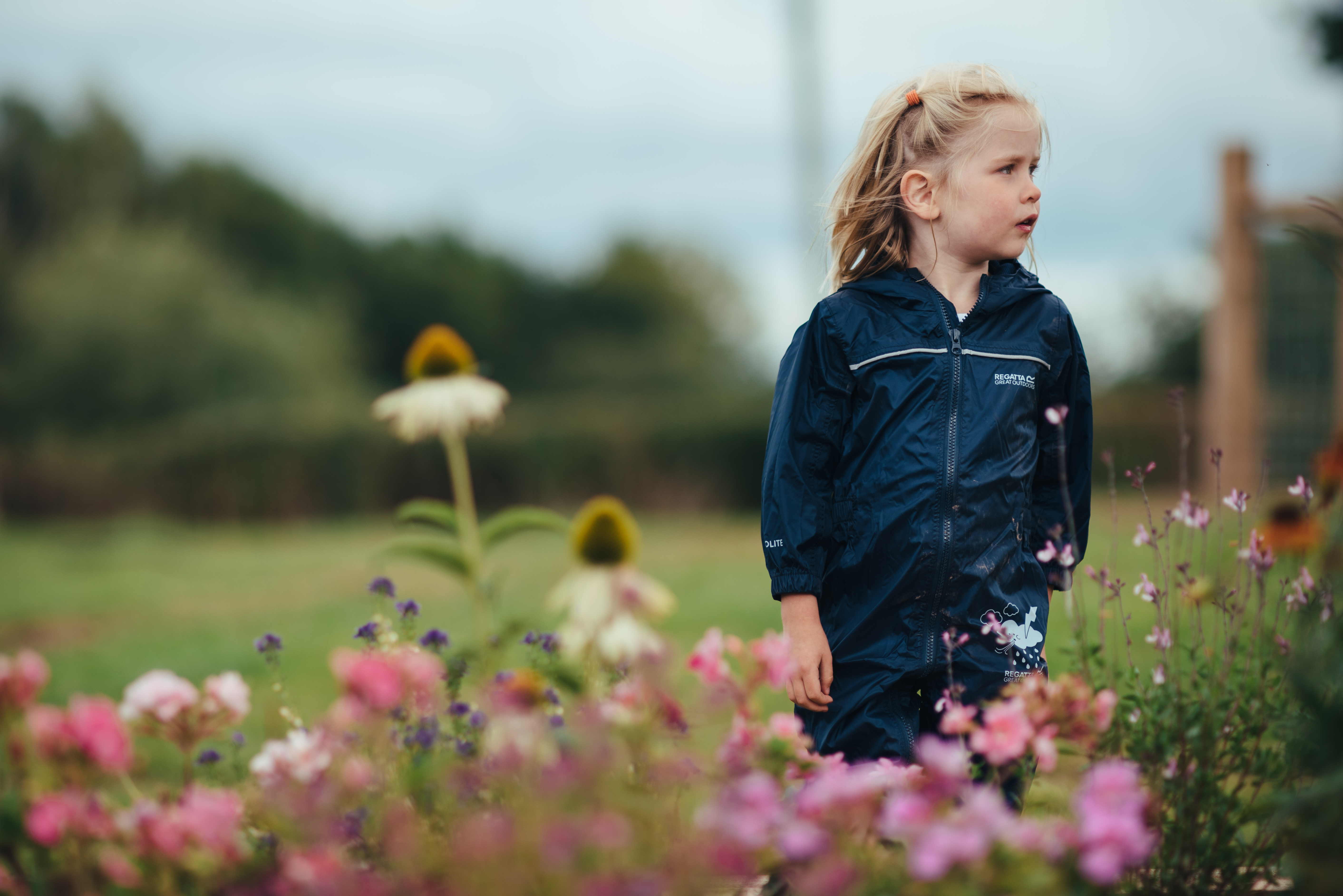 Young girl standing amongst flowers