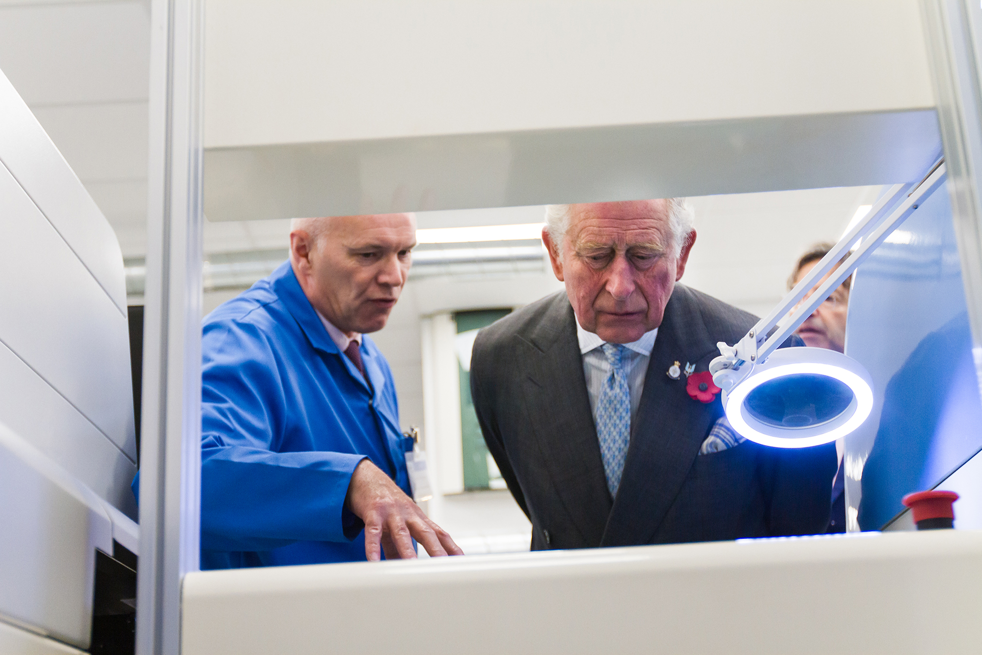 Image of Prince Charles looking at machinery