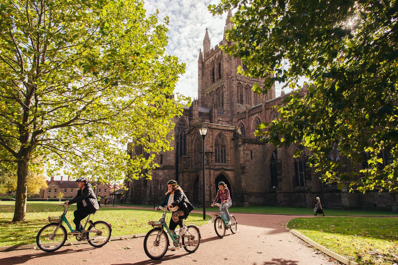 Promotional Photography - Students cycling past cathedral