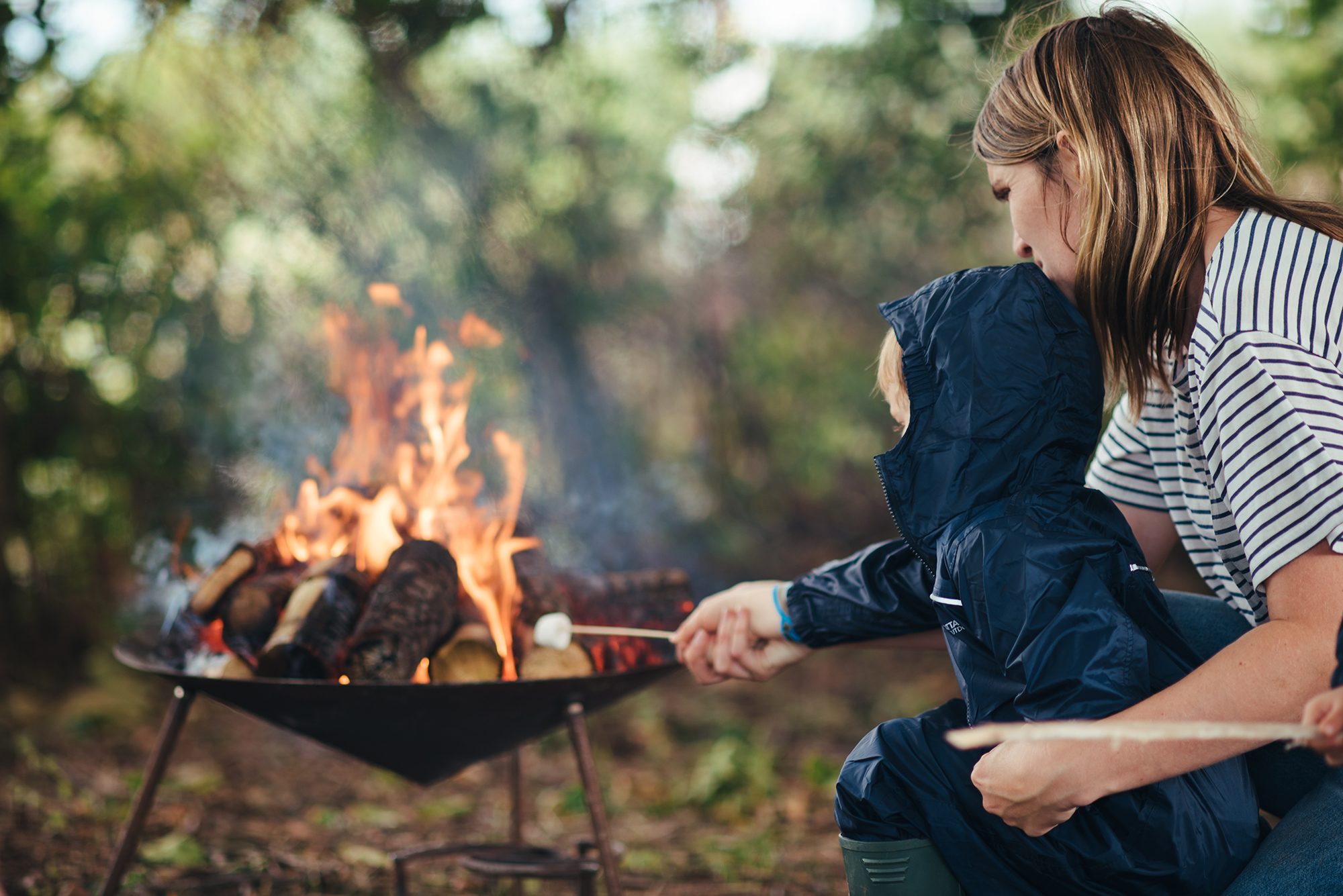 Parent and child roasting marshmallows on fire